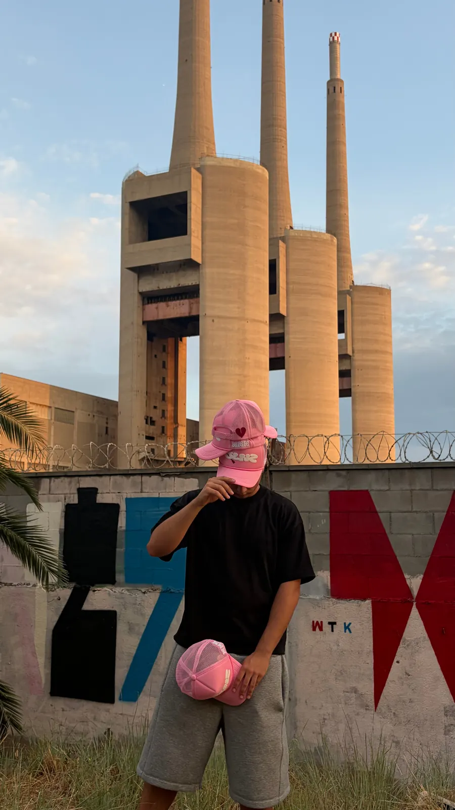 Pink GALNEZ cap worn in front of the abandoned Sant Adrià chimneys