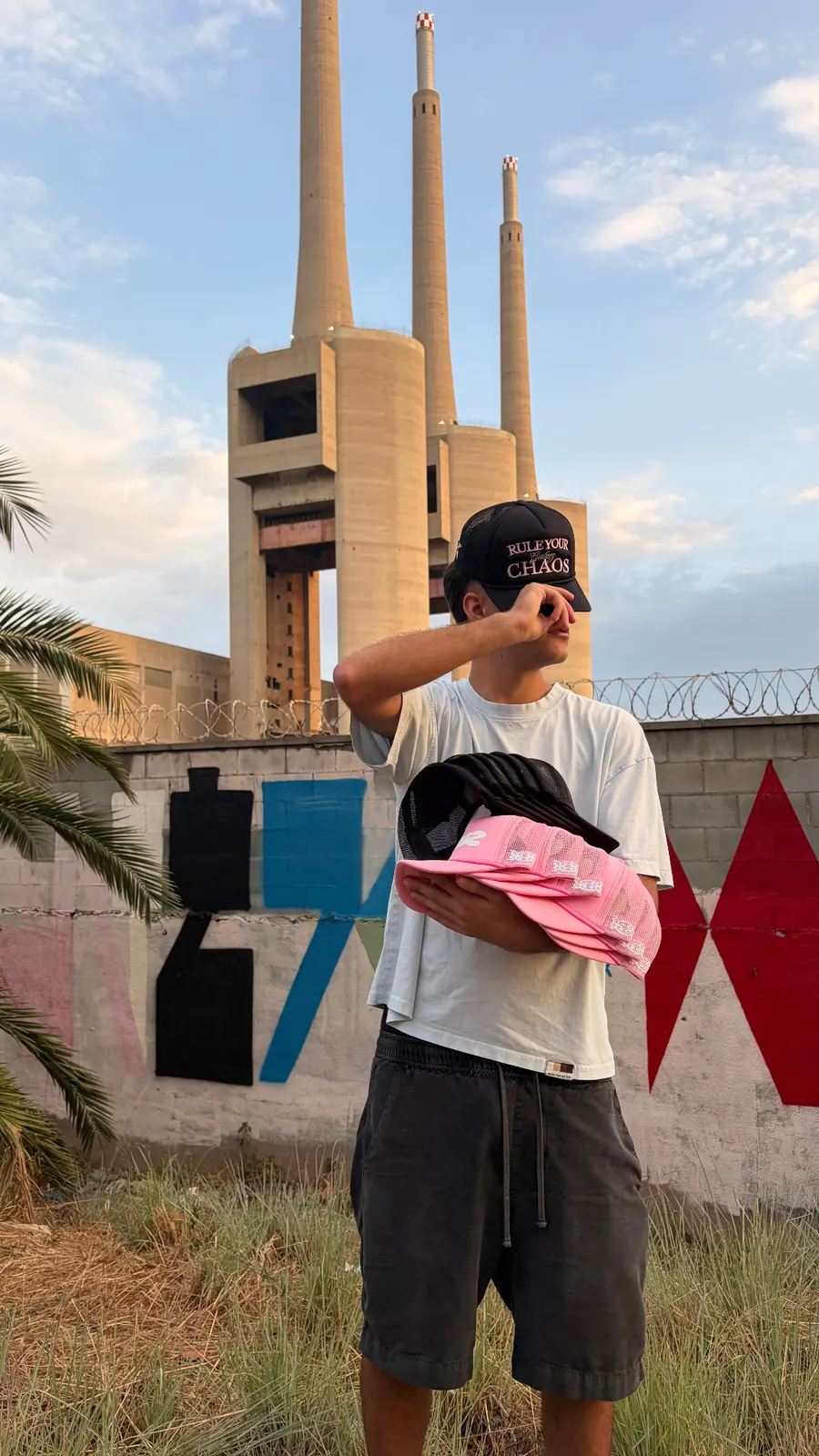 Black GALNEZ Rule Your Chaos cap worn against Barcelona chimneys skyline